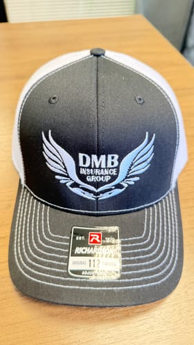 DMB Insurance Group logo embroidered on a gray and white trucker cap