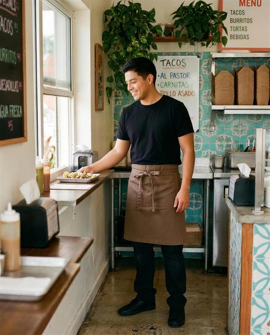 Taqueria counter: restaurant staff in custom embroidered Walnut 1081 canvas half apron with logo
